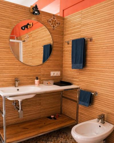 a bathroom with a sink and a mirror and a toilet at Il club degli scacchi in San Lorenzo del Vallo