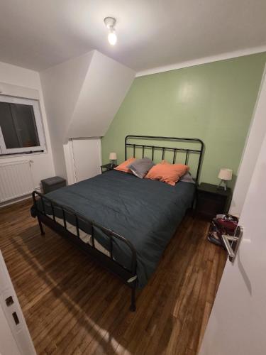 a bedroom with a bed with orange pillows on it at Ti a mor in Carnac