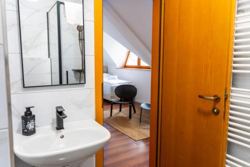 a bathroom with a sink and a mirror at Nidum - Šariš Park Hotel & Wellness in Prešov