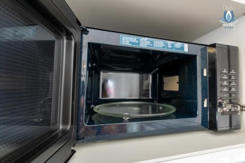 a microwave oven with a plate inside of it at Daria Boutique Hotel in Eforie Sud