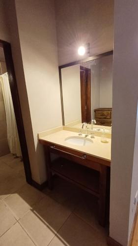 a bathroom with a sink and a large mirror at Casa Tala in Villa Las Rosas