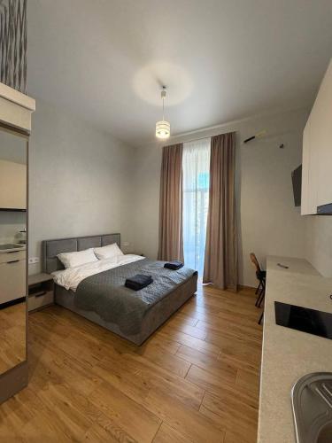 a bedroom with a bed and a large window at Green door in Kolomiya
