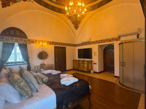 a bedroom with a large bed in a room with a ceiling at Kervansaray Antique Hotel in Çeşme