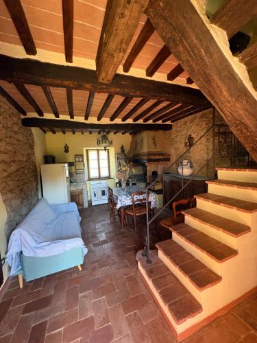a kitchen and a living room with a staircase in a house at Appartamento Puliesini in Montieri