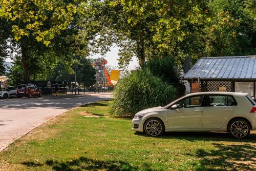 a small car parked on the grass near a playground at Urška's Premium House Terme Čatež in Brežice