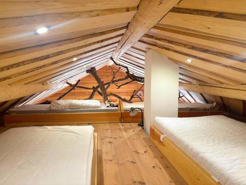 two beds in a small room with wooden ceilings at Fjällstugan in Sund