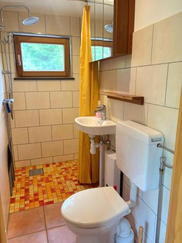 a small bathroom with a toilet and a sink at Fjällstugan in Sund