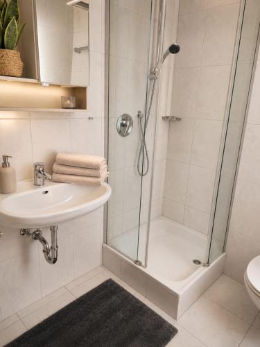 a bathroom with a shower and a sink at Hotel zur Linde in Berghausen