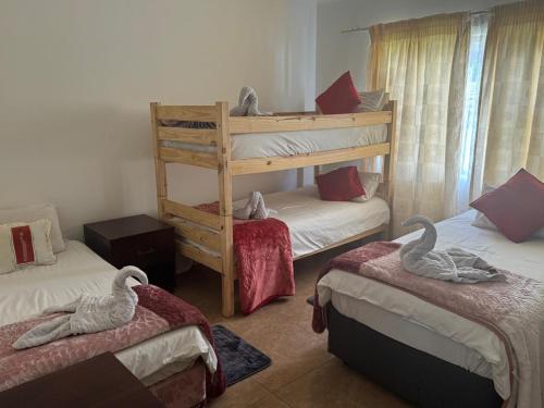 two swans are sitting on two beds in a room at Bouleigh in Kempton Park