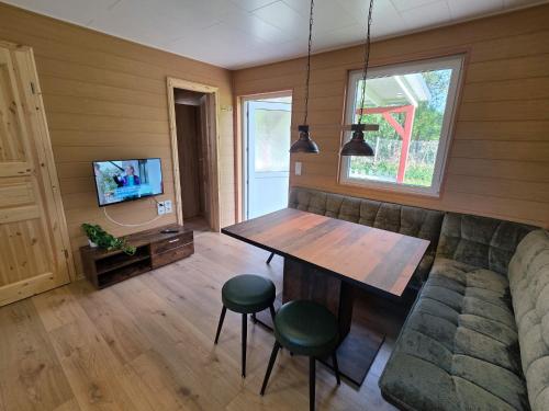 a living room with a table and a couch at Bungalow Seedorf 9 in Basedow
