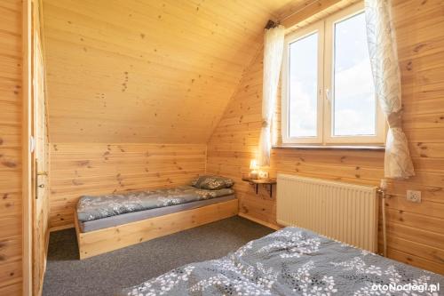 a sauna with two beds and a window at Sowie wzgórze in Krynica Zdrój