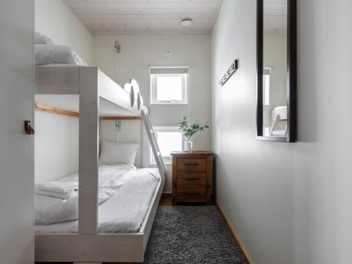 a bedroom with a bunk bed and a mirror at Spacious Slopeside Home with Sauna in Åre