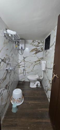 a bathroom with a toilet and a sink at Tuljapur Bhaktaniwas in Tuljapur
