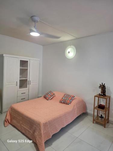 a bedroom with a bed with two pillows on it at Studio ALIZÉS in Le Moule