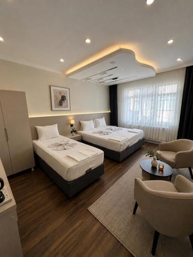 a hotel room with two beds and a couch at Kumkapı Hotel - Special Category in Istanbul