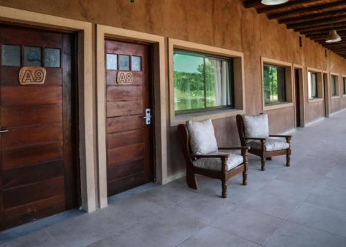 two chairs in a hallway with two doors and windows at Terrazas de Lobos in Lobos