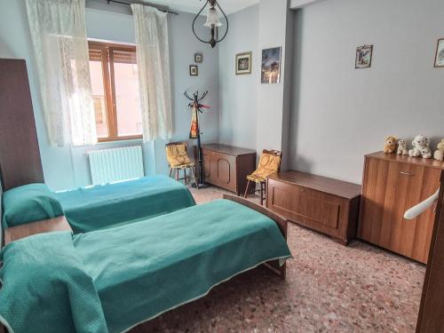 a bedroom with two beds and a dresser at DeLiA in Avellino