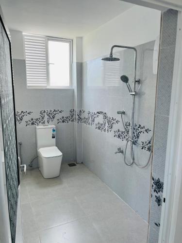 a bathroom with a shower and a toilet at Letharo Residancies in Dodanduwa
