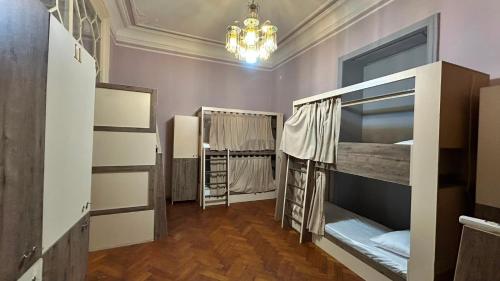 a room with two bunk beds and a chandelier at BakuDowntownHostel in Baku