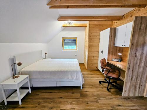 a bedroom with a bed and a desk at Pirman Vineyard Cottage in Bučka