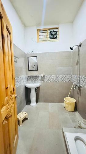 a bathroom with a sink and a toilet in it at CLOUD HEIGHTS COTTAGE NATHIA GALi in Nathia Gali