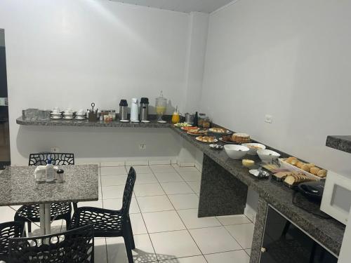 a kitchen with a long counter with food on it at Hotel Goiamat in Querencia