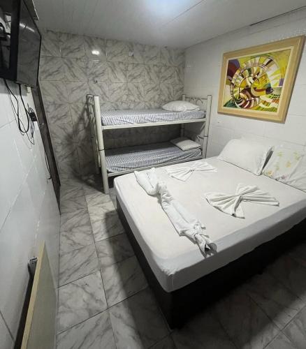 a bedroom with two bunk beds in it at Pousada do Benzinho in Cabedelo