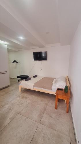 a bedroom with a bed and a tv on the wall at Basel city in Basel