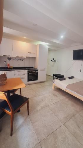 a room with a bed and a table and a kitchen at Basel city in Basel