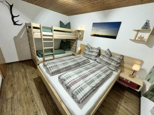 a bedroom with a bunk bed with pillows and a ladder at apart-gerlos in Gerlos