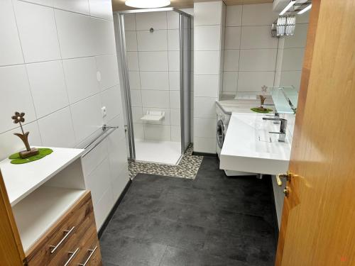 a bathroom with two sinks and a walk in shower at apart-gerlos in Gerlos