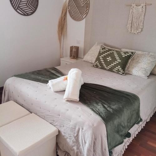 a bedroom with a bed with a towel on it at Casa Dulce in Villaviciosa