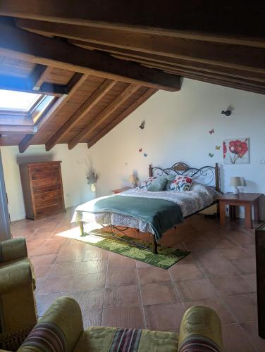 a bedroom with a bed in a room with wooden ceilings at Monterosa Apartment in Morghengo