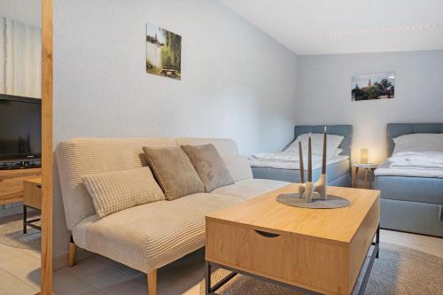 a living room with a couch and a table at Fewo Gustav Melkert Str. 5A in Röbel