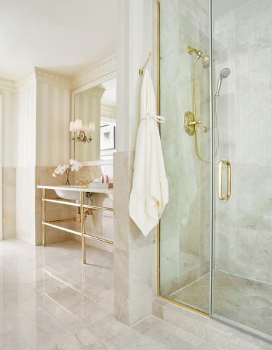a bathroom with a shower with a glass door at The Hay - Adams in Washington, D.C.
