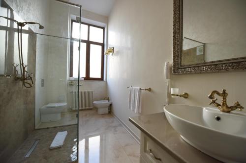 a bathroom with a sink and a shower and a toilet at Euro Hotel Grivita in Bucharest