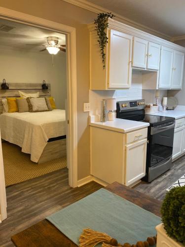 a kitchen and a bedroom with a bed in a room at Lucky 13 Condo in Starkville