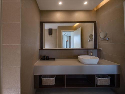 a bathroom with a sink and a mirror at Things grow in their native land in Ulanqab
