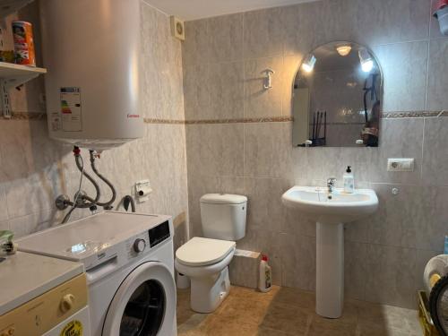a bathroom with a washing machine and a sink at La dorada 8 in Torroella de Montgrí
