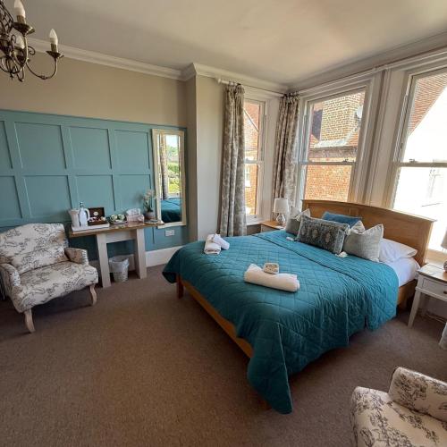 a bedroom with a bed with two towels on it at Gordon House in Wimborne Minster