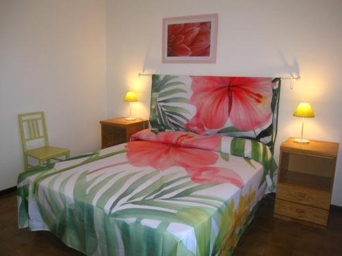 a bedroom with a bed with flowers on it at Appartamento Brubelpi in Lido