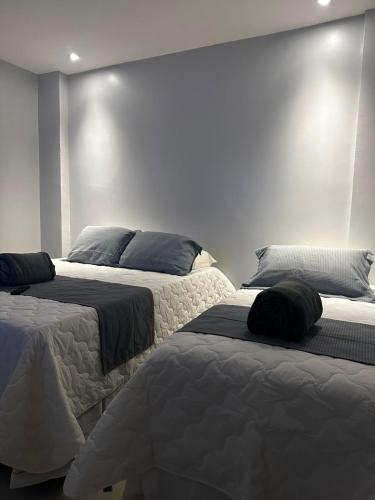 two beds sitting next to each other in a bedroom at Arruda UMARI in Benevides