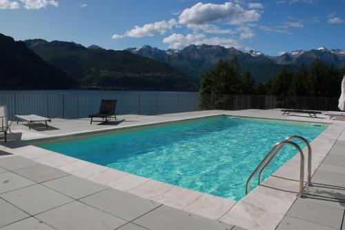 a swimming pool with a view of the mountains at Residence Il Poggio in Dorio