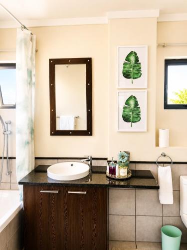 a bathroom with a sink and a mirror at MANDITAZ STUDIO in Fourways