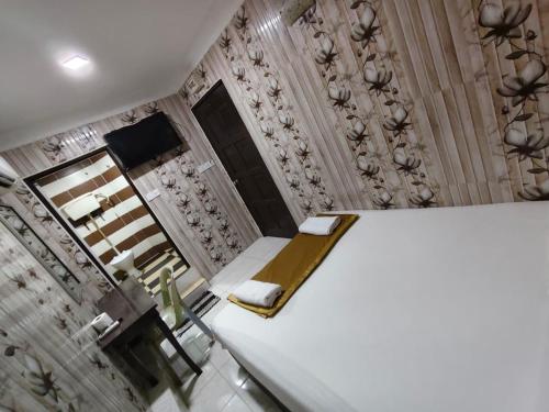a room with a white bed and a mirror at New Wave Damansara Damai in Petaling Jaya