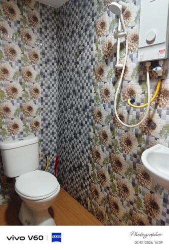 a bathroom with a toilet and a sink at New Wave Damansara Damai in Petaling Jaya