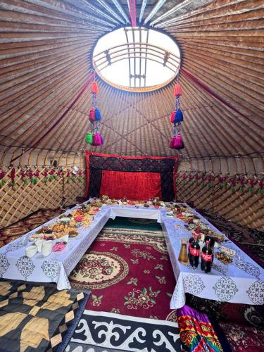 a room with a bed in a yurt at Almani yurt camp in Tong