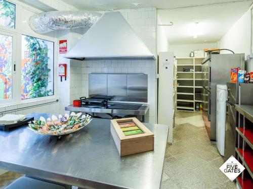 a kitchen with a table with a bowl of food on it at Hostal Five Gates in Osuna