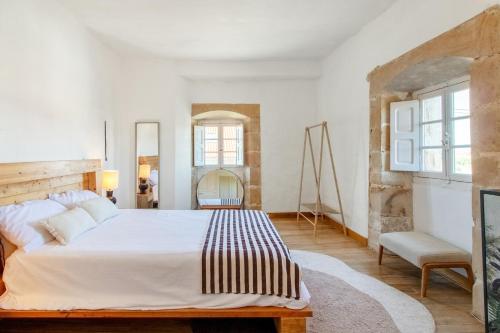a white bedroom with a large bed and a chair at Villa Vista Ajo in Ajo