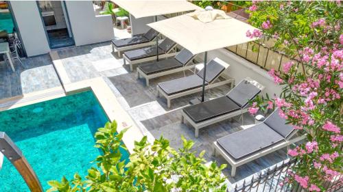 an overhead view of a patio with chairs and a pool at ADA BOUTİQUE HOTEL in Marmaris